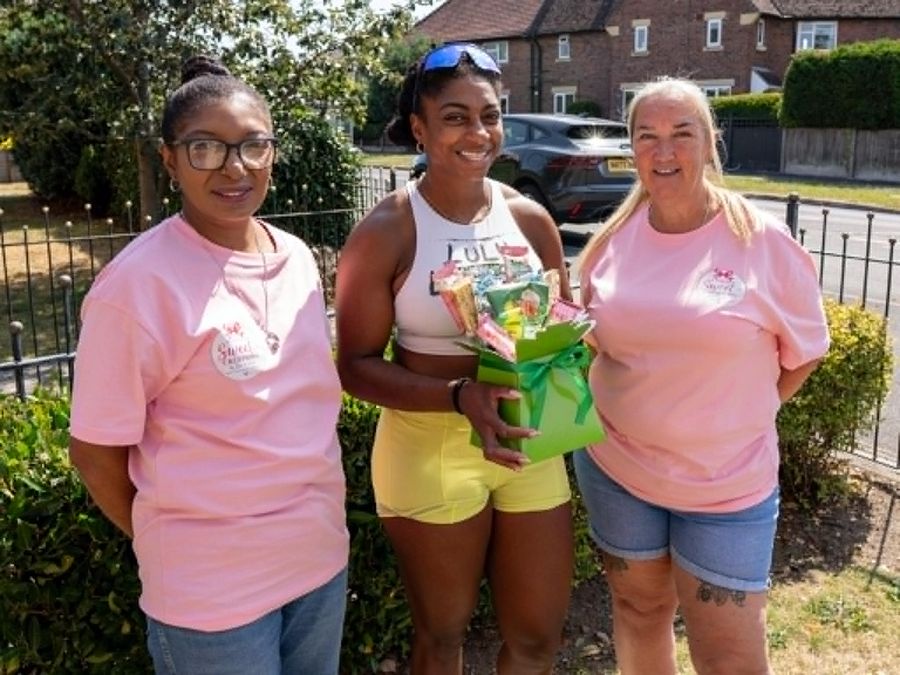 Dee and Debs presenting a sweet bouquet to Kadeena Cox