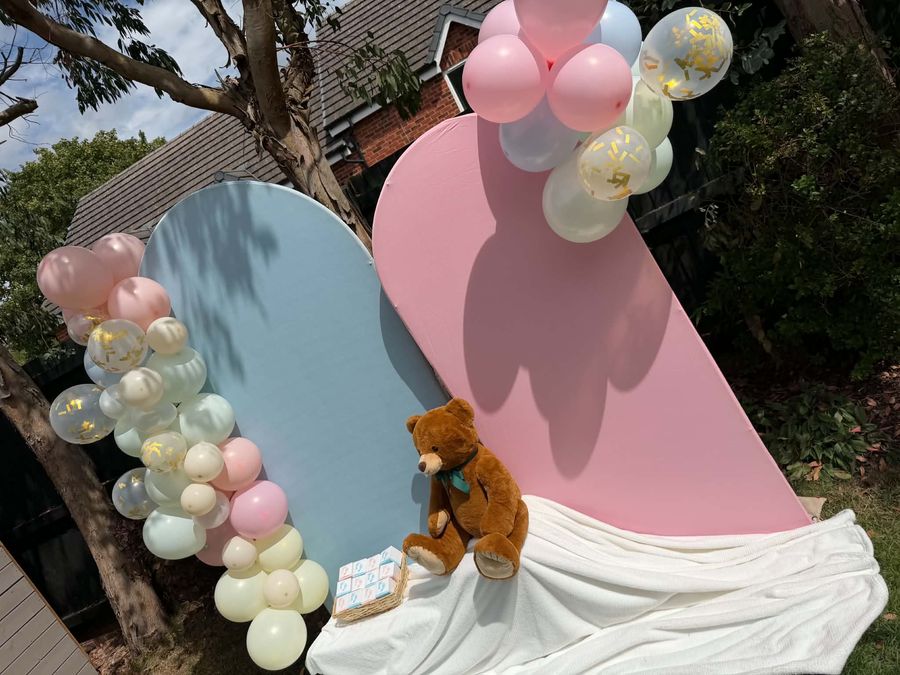 Celebration setup featuring baby shower backdrop