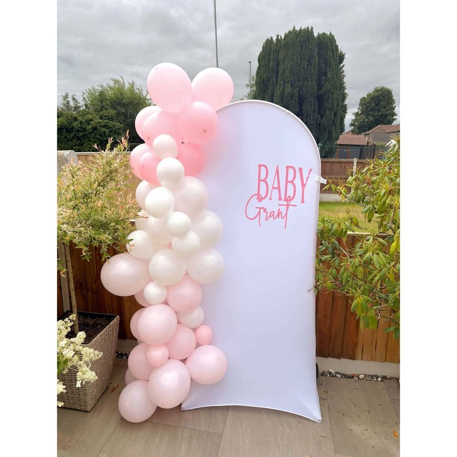 Celebration setup featuring balloon arch backdrop