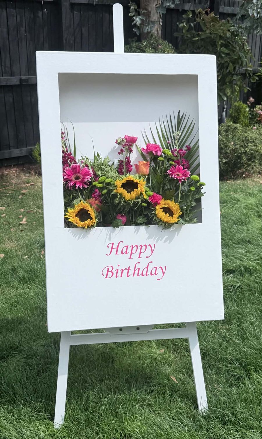 Celebration setup featuring birthday floral sign