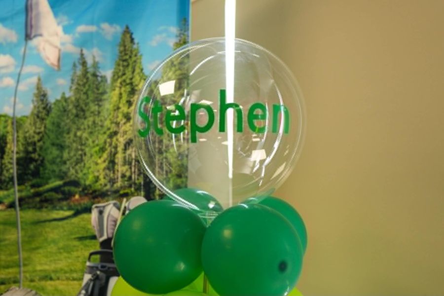 Celebration setup featuring personalised balloon green